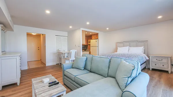 a bedroom with a large bed and a flat screen tv