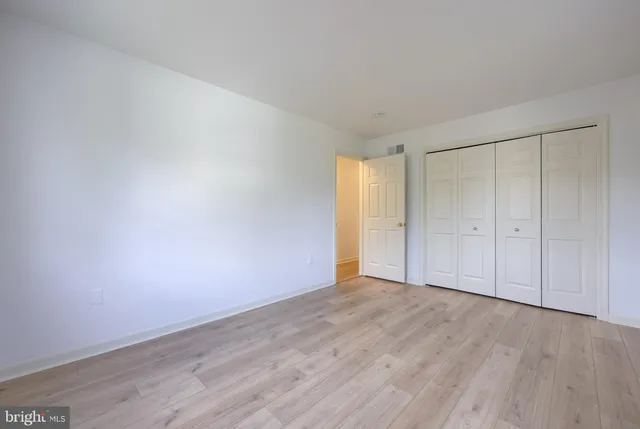 a view of an empty room and wooden floor
