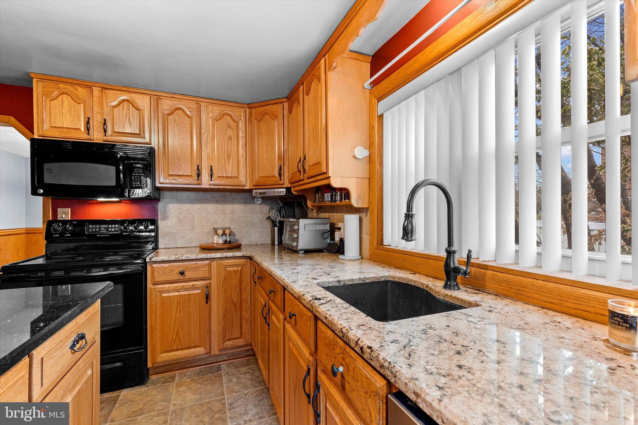 2279 Manor Road York, PA 17408 - Photo 12 of 27 a kitchen with stainless steel appliances granite countertop a sink a stove and a microwave