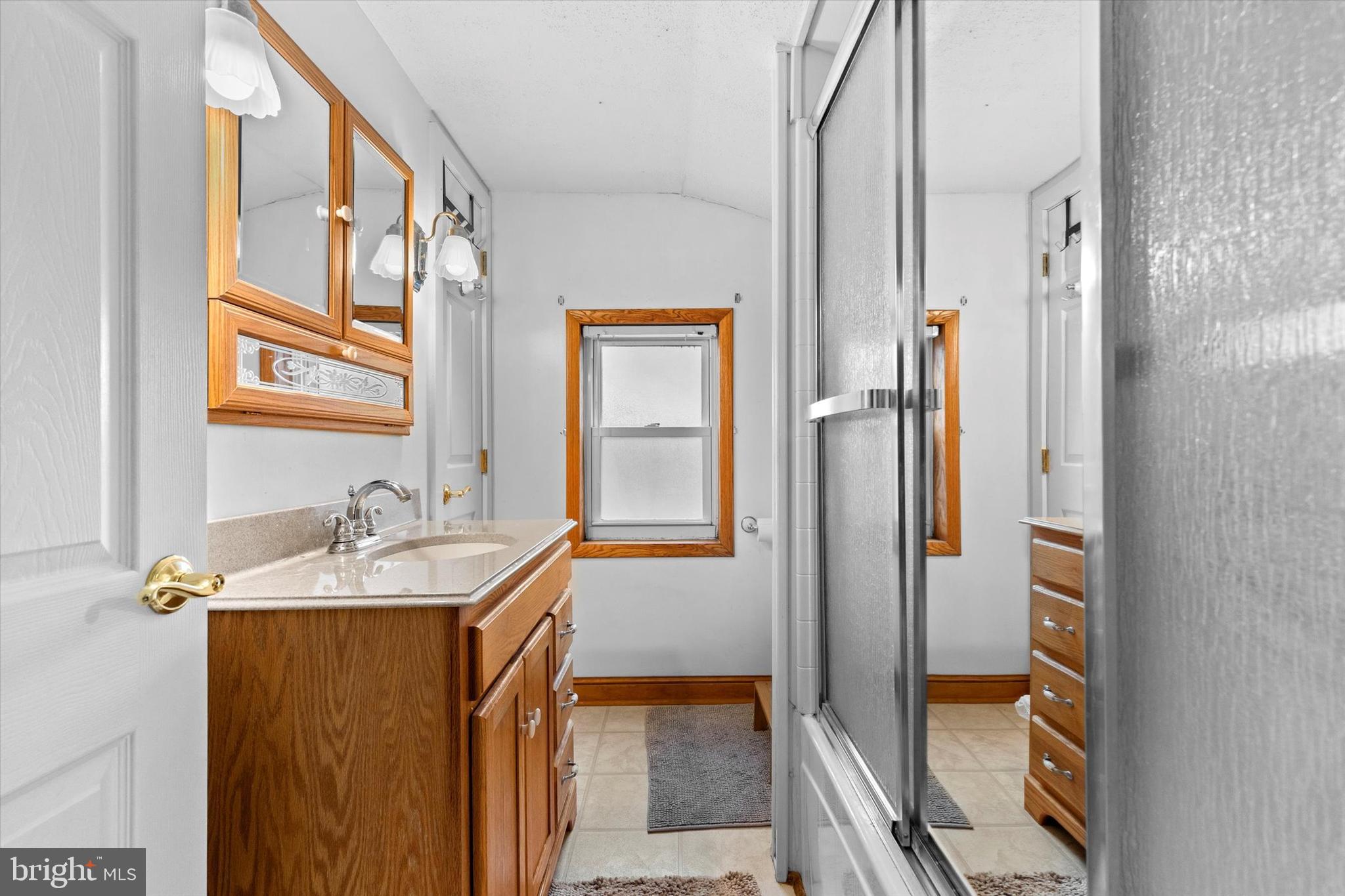 2279 Manor Road York, PA 17408 - Photo 14 of 27 a en suite bathroom with a granite countertop sink and a large mirror