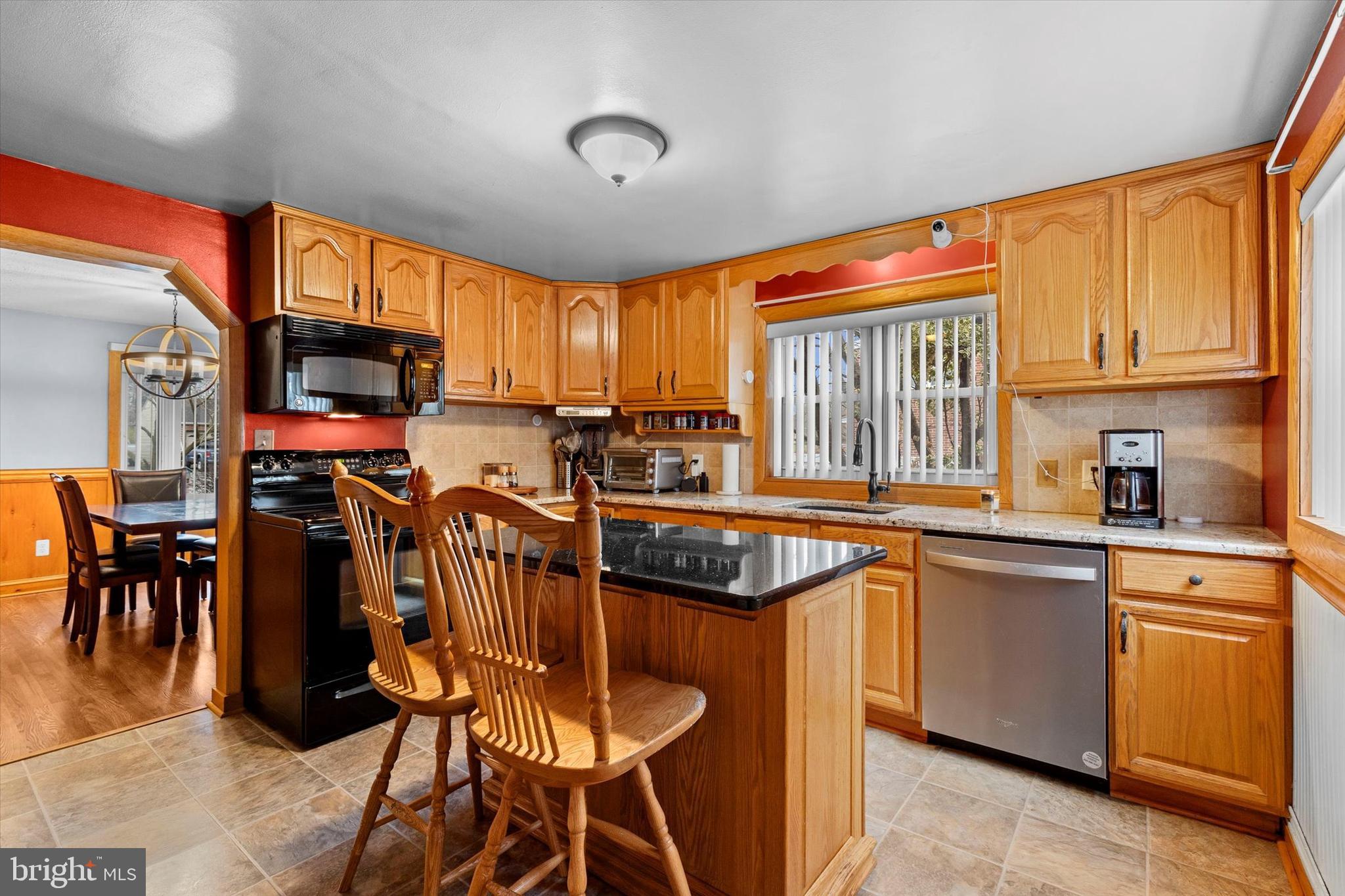 2279 Manor Road York, PA 17408 - Photo 10 of 27 a kitchen with stainless steel appliances granite countertop a stove top oven a sink a dining table and chairs