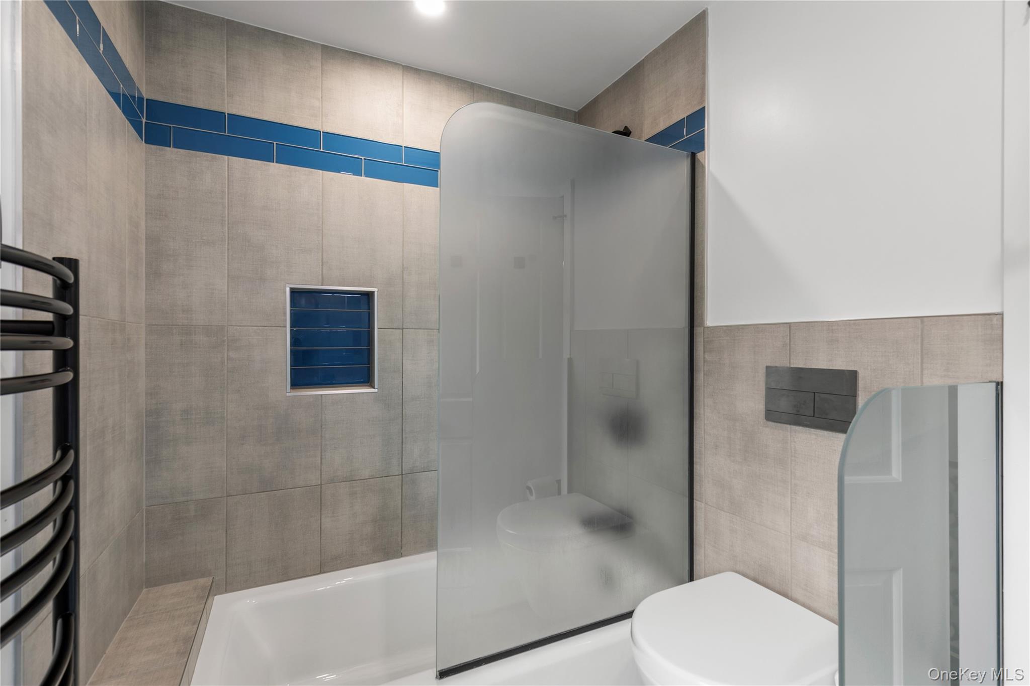 19 John Jay Place Rye, NY 10580 - Photo 33 of 45 The shower/tub combination, the heated towel rack and the partitioned toilet make this bathroom spacious and functional.