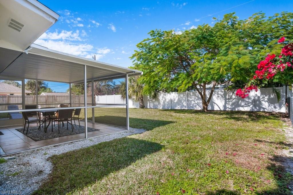 1207 Hernando Street Naples, FL 34103 - Photo 30 of 37 a view of a patio with a table and chairs under an umbrella