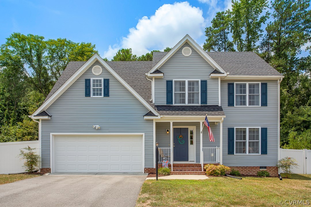 10724 Ethens Mill Road Chester, VA 23831 - Photo 1 of 27 a front view of a house with a yard and garage