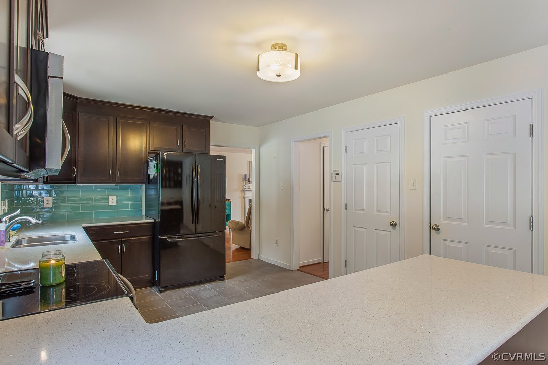 10724 Ethens Mill Road Chester, VA 23831 - Photo 15 of 27 a kitchen with stainless steel appliances kitchen island granite countertop a refrigerator and a sink