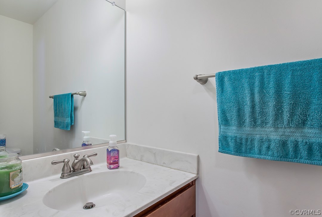 10724 Ethens Mill Road Chester, VA 23831 - Photo 17 of 27 a bathroom with a sink and a mirror