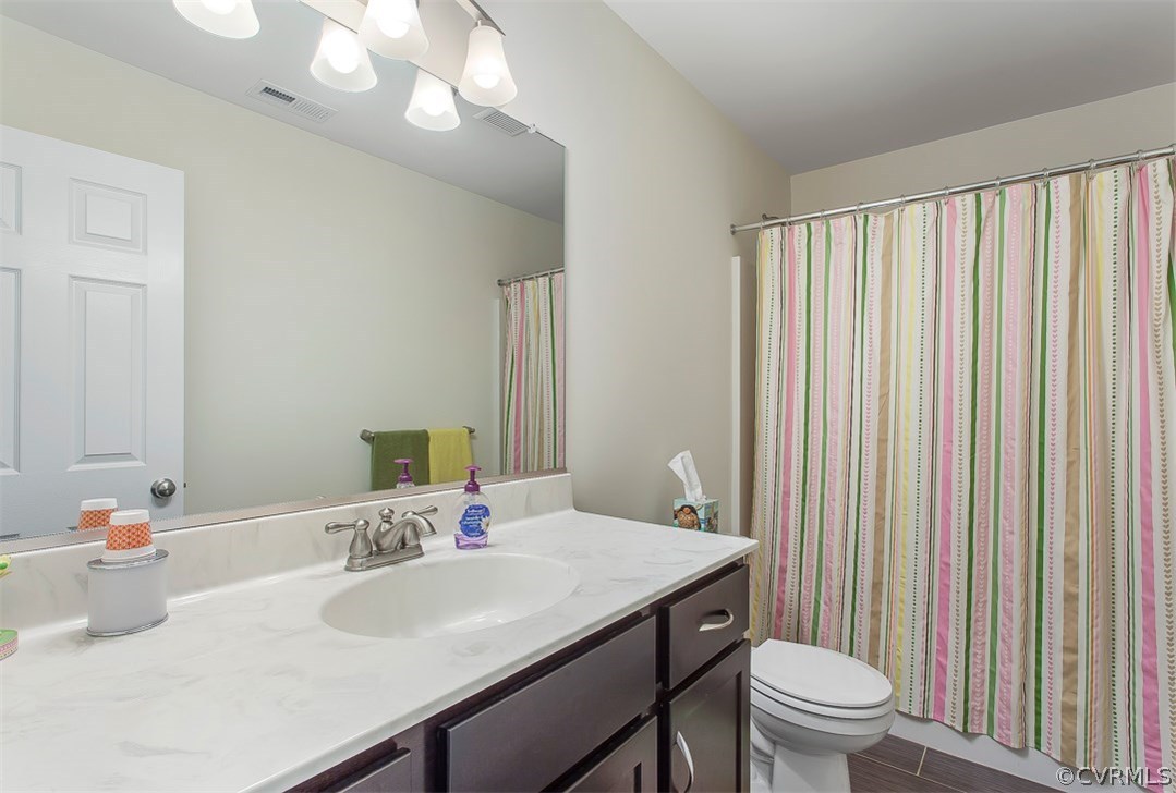 10724 Ethens Mill Road Chester, VA 23831 - Photo 20 of 27 a bathroom with a sink toilet and a mirror