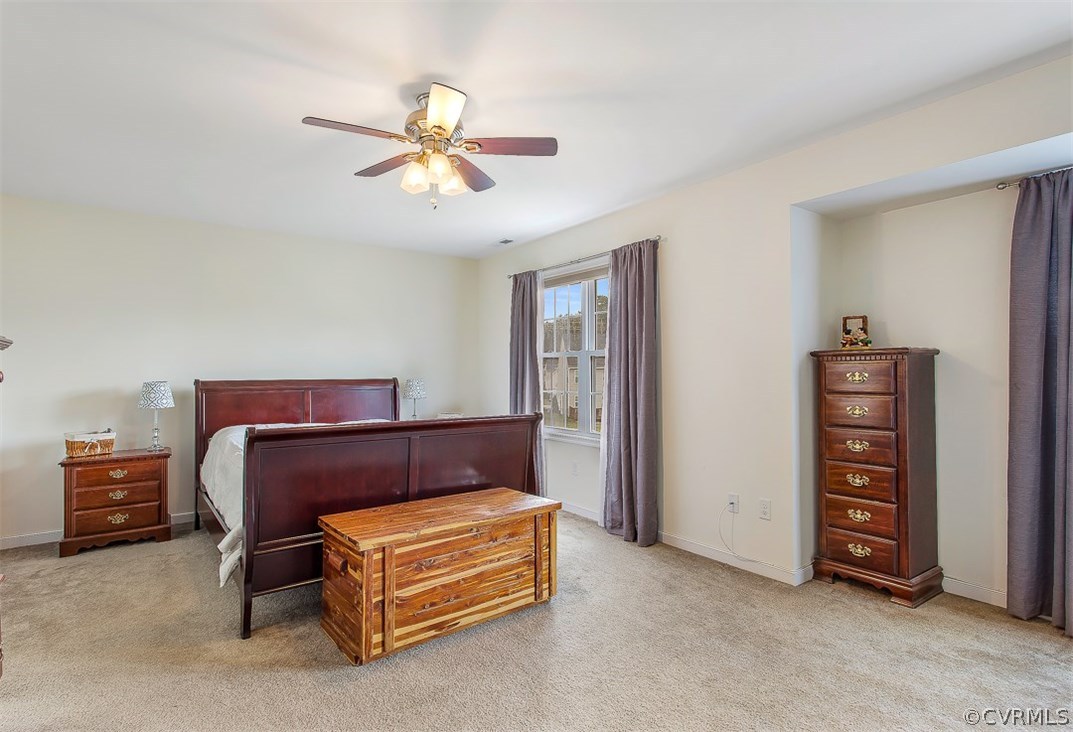 10724 Ethens Mill Road Chester, VA 23831 - Photo 23 of 27 a bedroom with a bed and a ceiling fan