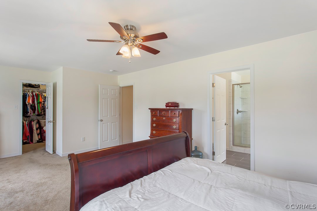 10724 Ethens Mill Road Chester, VA 23831 - Photo 25 of 27 a bedroom with a large bed and a chandelier