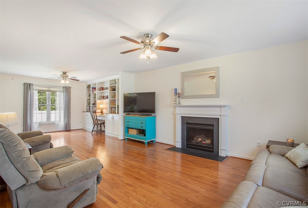 10724 Ethens Mill Road Chester, VA 23831 - Photo 9 of 27 a living room with furniture a fireplace and a flat screen tv