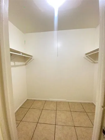 a view of a livingroom with an empty space and a hallway