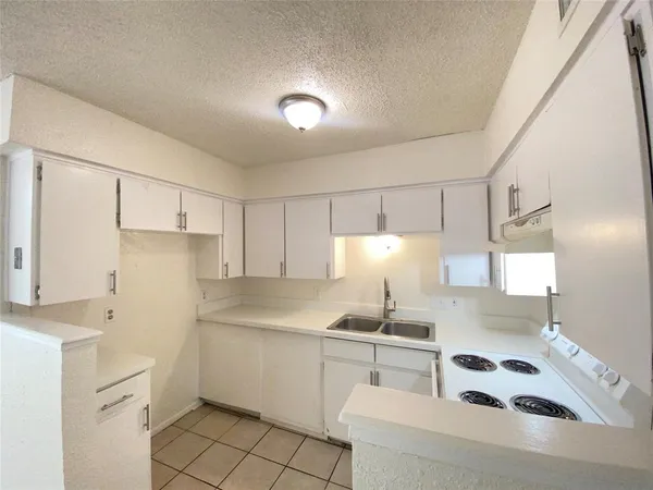 a kitchen with a sink cabinets and stainless steel appliances