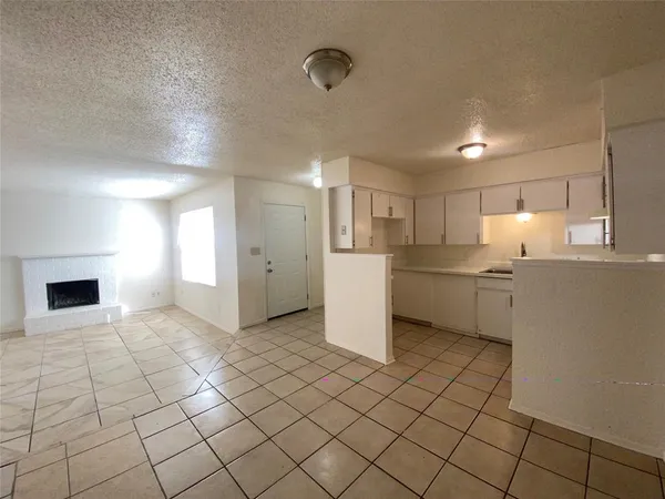 a view of a kitchen with a sink and a refrigerator