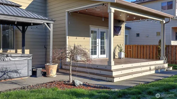 a view of house with backyard and sitting area