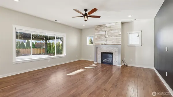 a view of an empty room with a fireplace and a window