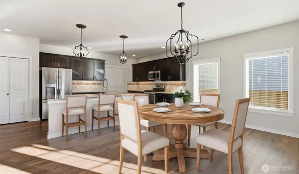 a view of a dining room with furniture a chandelier and wooden floor