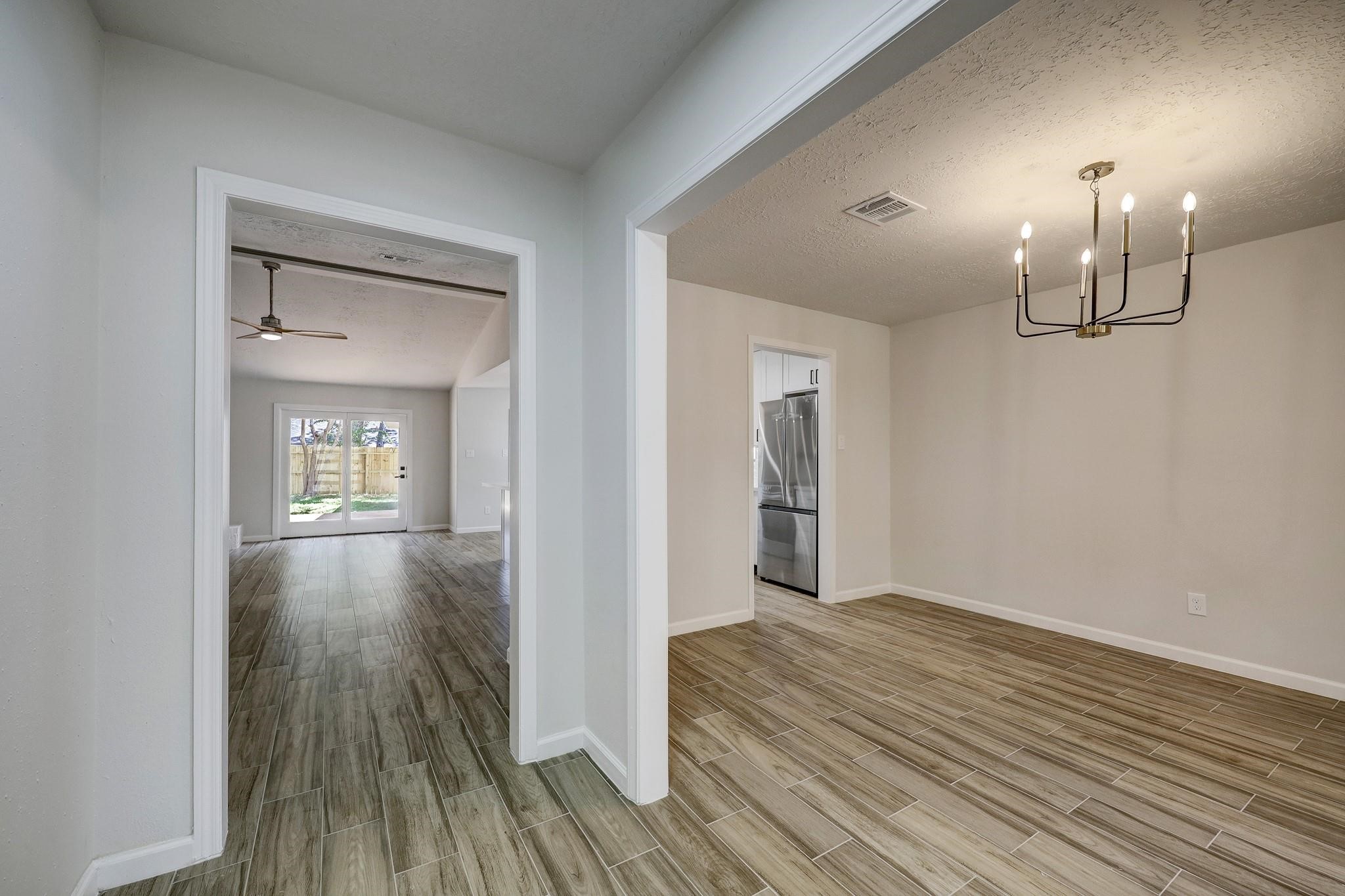 9723 Galston Lane Spring, TX 77379 - Photo 24 of 24 Upon entry, a clear line of sight leads through the open floor plan. The formal dining space is positioned to the right, while the vaulted living area unfolds ahead, drawing attention with its openness and natural light.