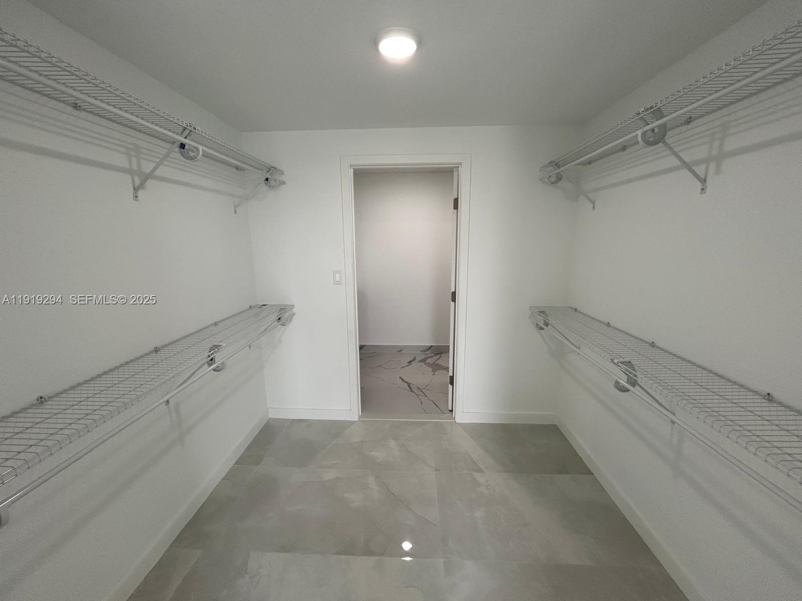 14568 Southwest 261st Terrace, Unit 2 Homestead, FL 33032 - Photo 11 of 22 a view of an empty walk in closet