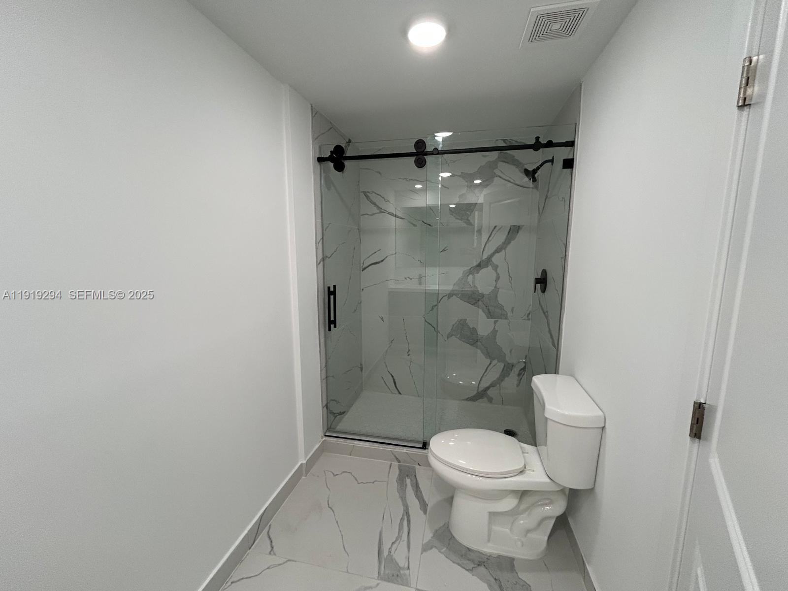 14568 Southwest 261st Terrace, Unit 2 Homestead, FL 33032 - Photo 13 of 22 a bathroom with a toilet and a shower