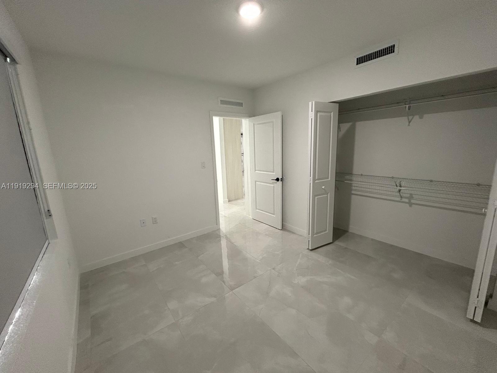 14568 Southwest 261st Terrace, Unit 2 Homestead, FL 33032 - Photo 15 of 22 a view of an empty room