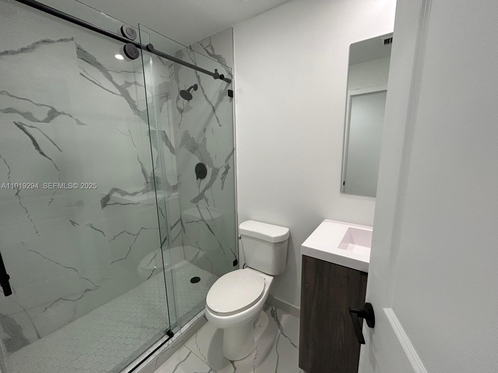 14568 Southwest 261st Terrace, Unit 2 Homestead, FL 33032 - Photo 16 of 22 a bathroom with a toilet and a shower
