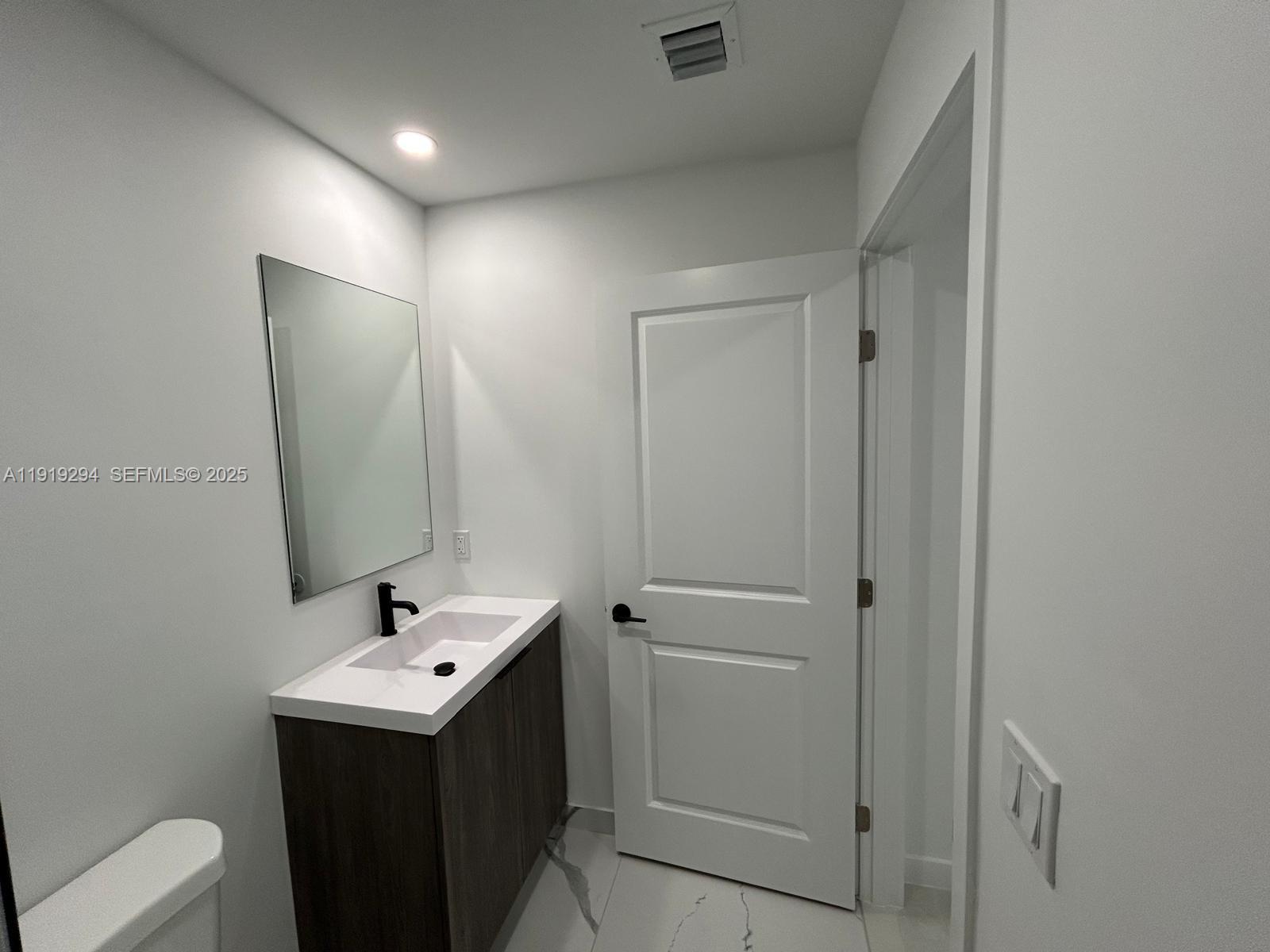 14568 Southwest 261st Terrace, Unit 2 Homestead, FL 33032 - Photo 17 of 22 a view of bathroom with a sink and mirror