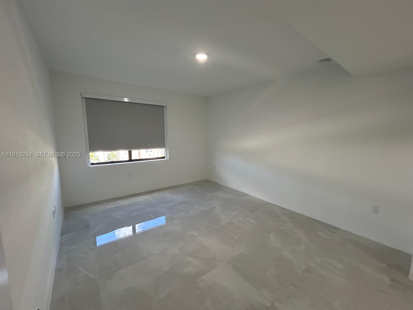 14568 Southwest 261st Terrace, Unit 2 Homestead, FL 33032 - Photo 8 of 22 a view of an empty room with a window