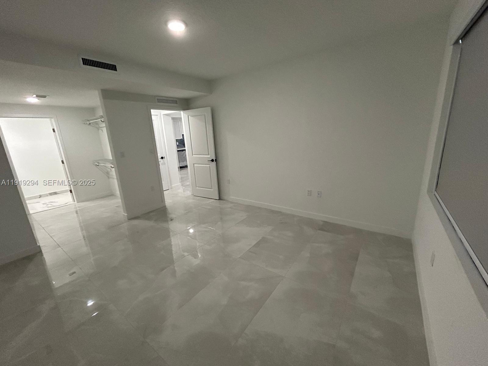 14568 Southwest 261st Terrace, Unit 2 Homestead, FL 33032 - Photo 9 of 22 an empty room with a bathroom