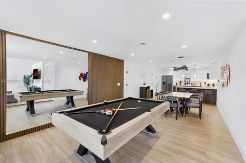 a living room with furniture and kitchen view