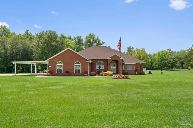 a front view of a house with a garden
