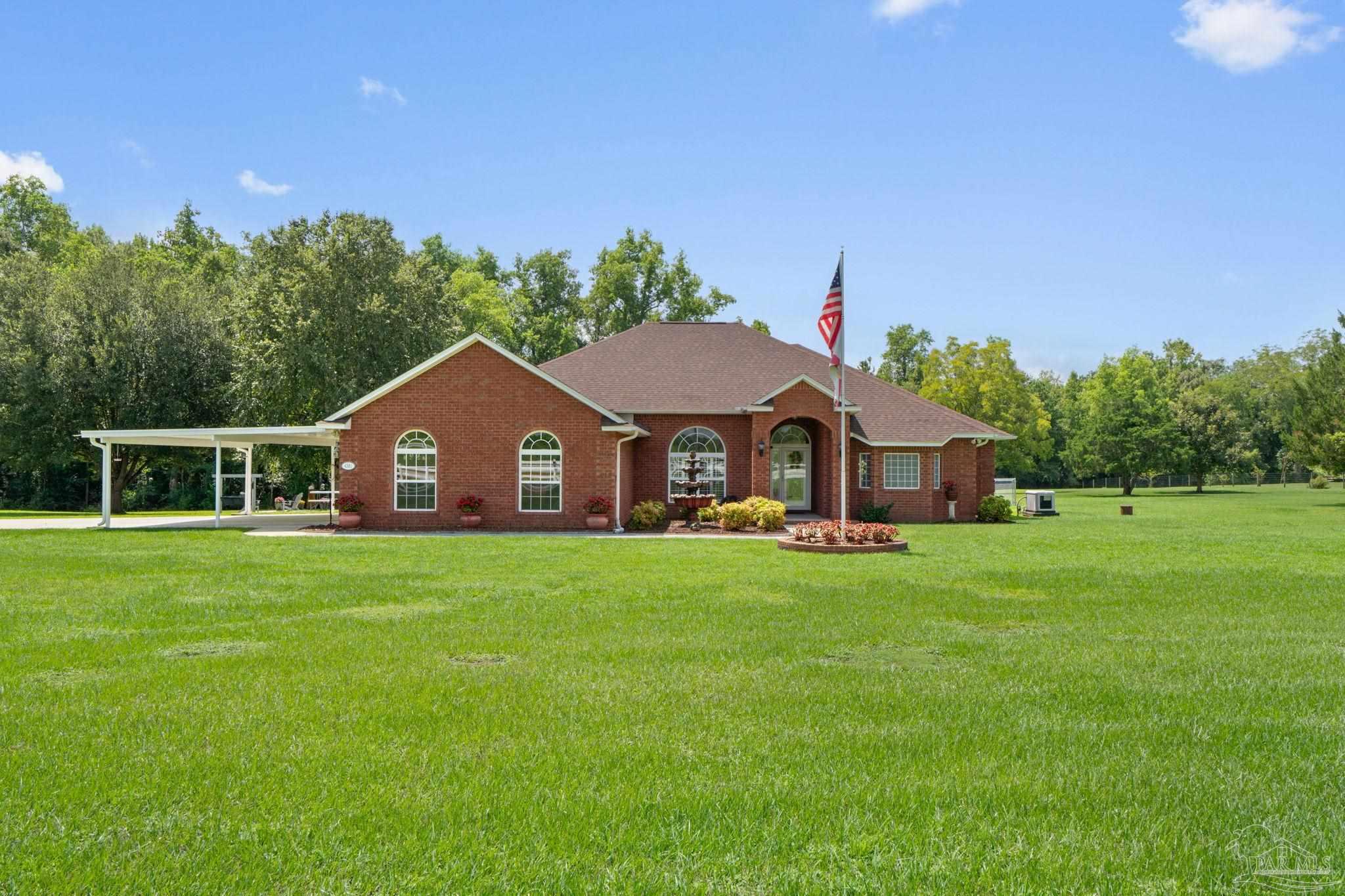 a front view of a house with a garden