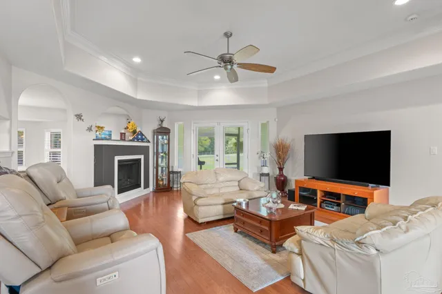 a kitchen with stainless steel appliances granite countertop a refrigerator a stove and a sink with wooden floor