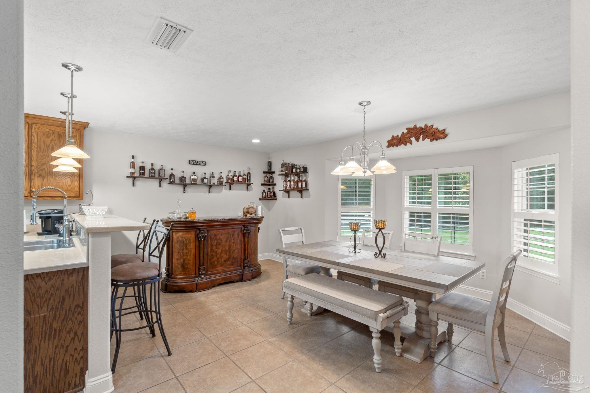 4381 Molino Road Molino, FL 32577 - Photo 16 of 72 a dining room with furniture and window