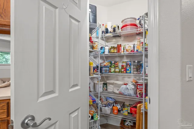a spacious bedroom with a large bed and a chandelier