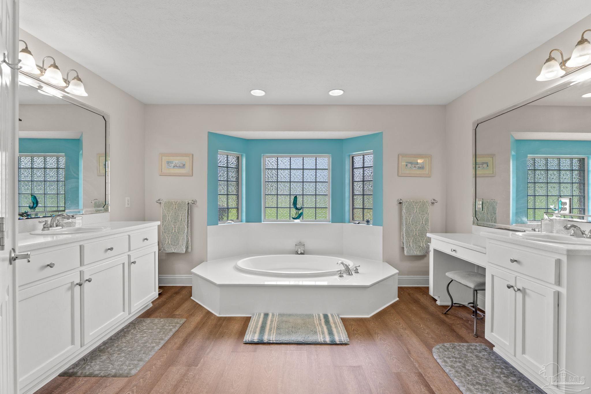 4381 Molino Road Molino, FL 32577 - Photo 32 of 72 a spacious bathroom with a granite countertop sink and a mirror