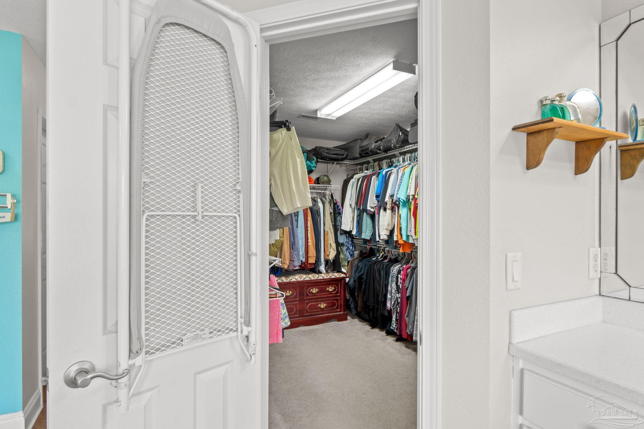 4381 Molino Road Molino, FL 32577 - Photo 36 of 72 a view of walk in closet with clothes