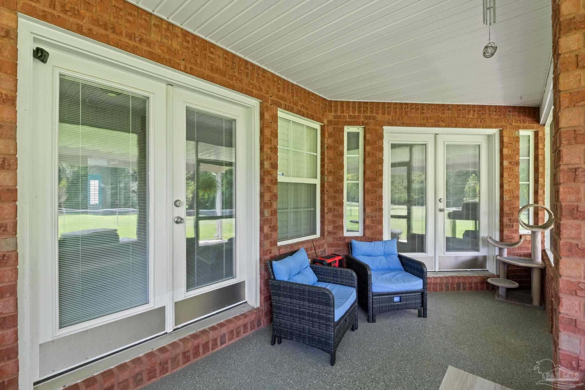 4381 Molino Road Molino, FL 32577 - Photo 39 of 72 a living room with furniture and a floor to ceiling window