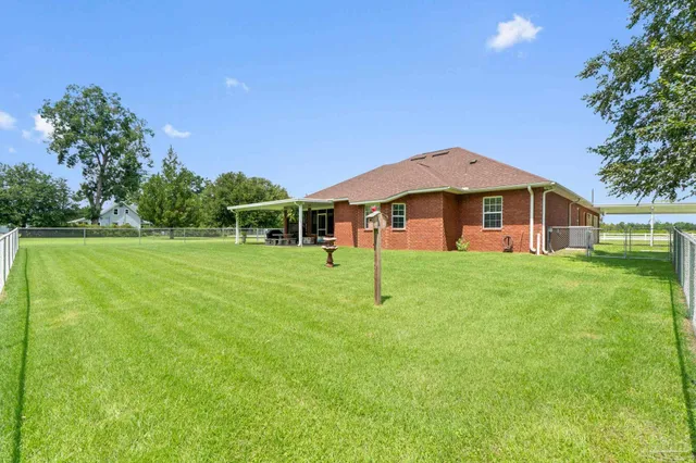 a swimming pool with outdoor seating and yard