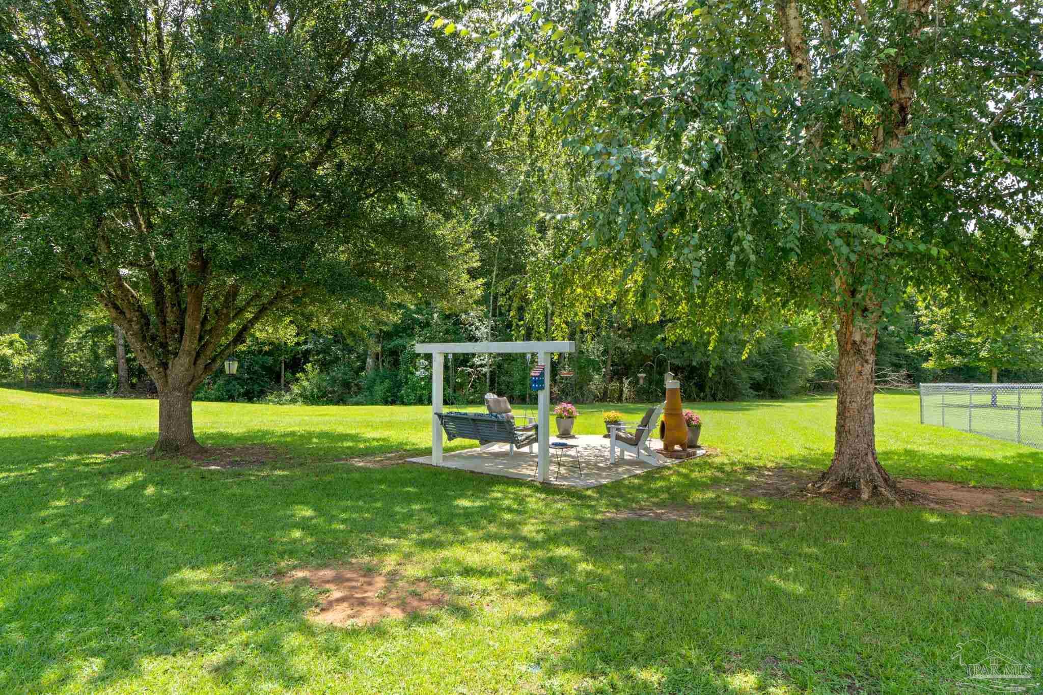 4381 Molino Road Molino, FL 32577 - Photo 45 of 72 a view of a swimming pool with a sitting space