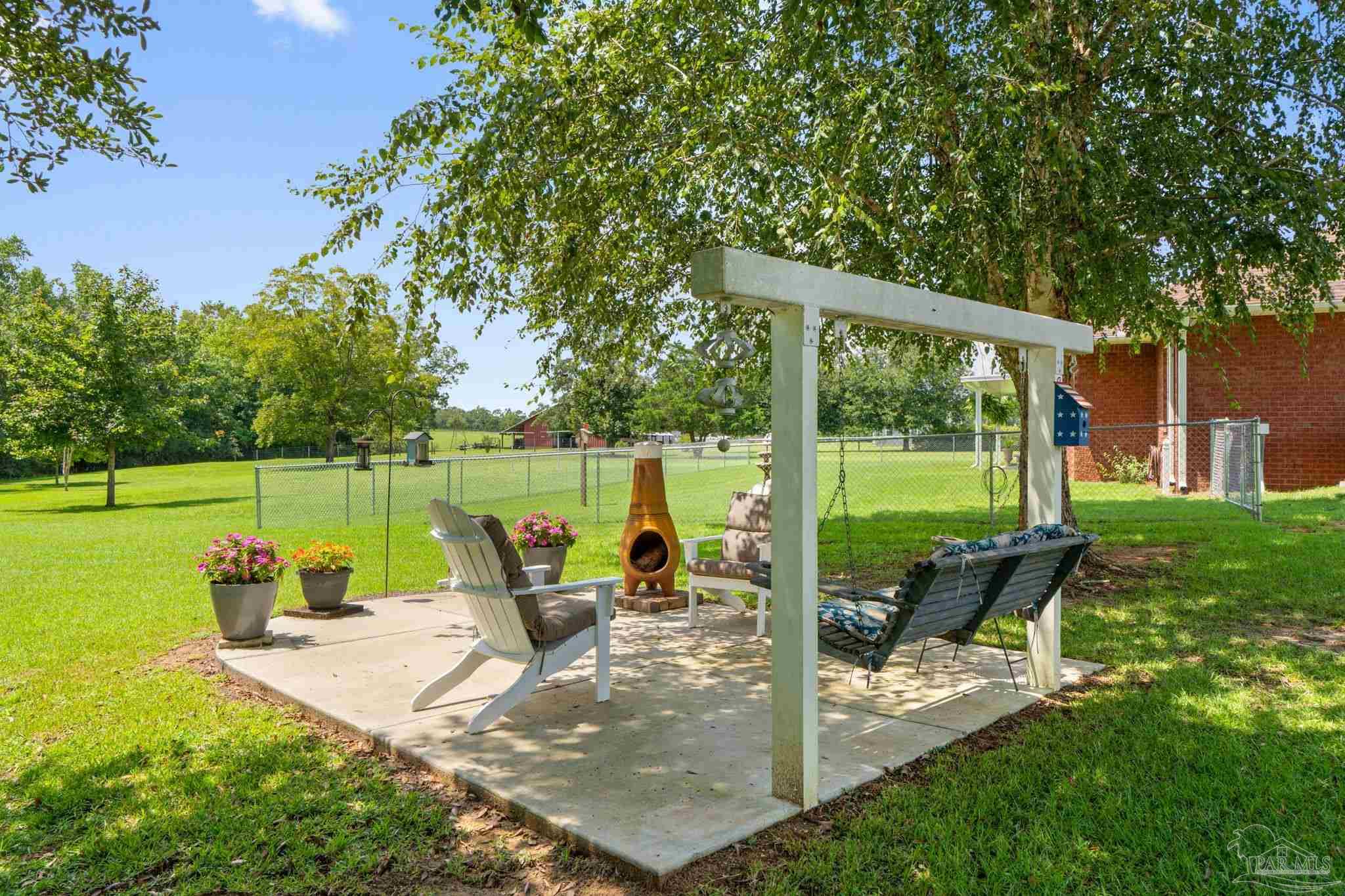 4381 Molino Road Molino, FL 32577 - Photo 46 of 72 a view of a park with sitting area and garden