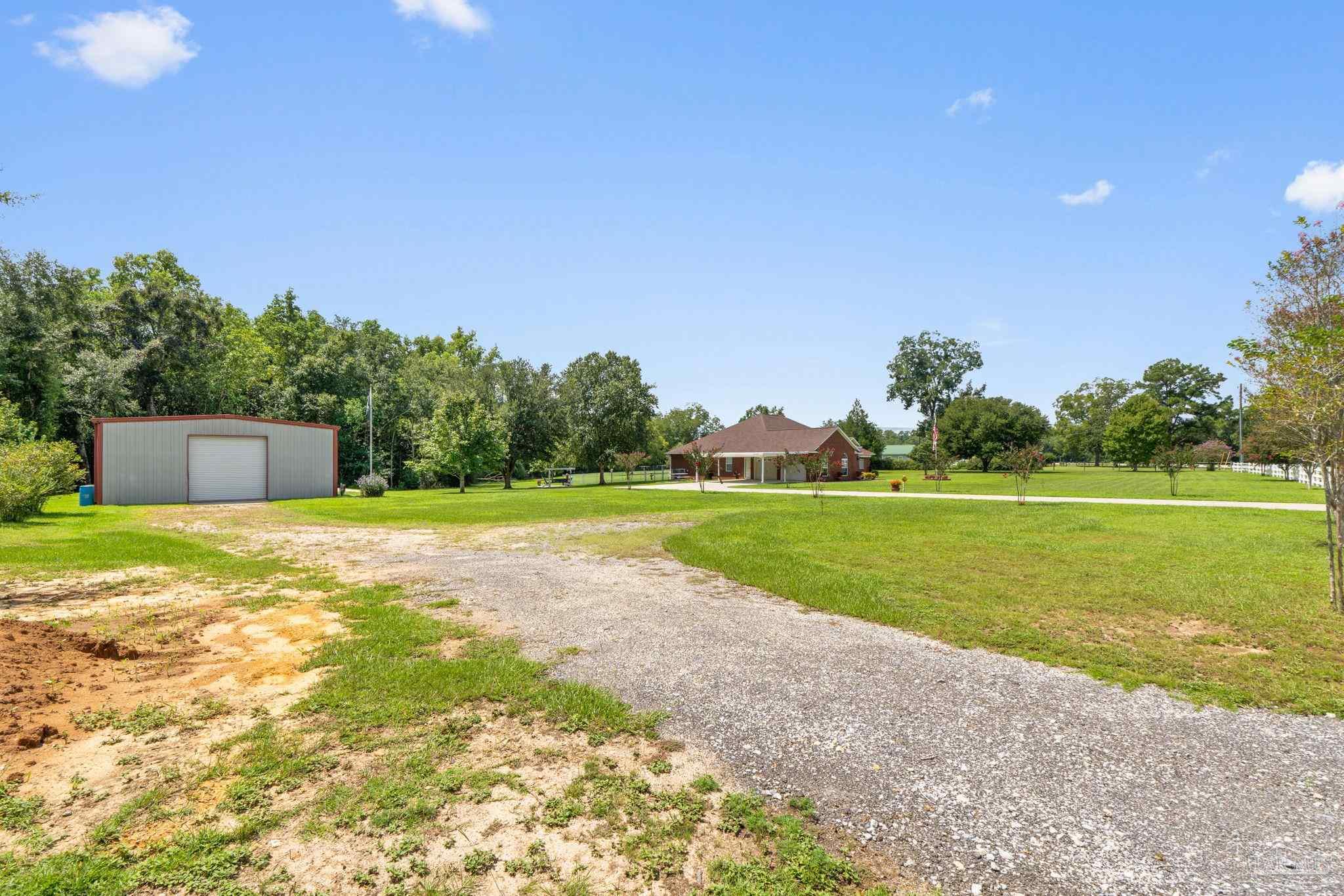 4381 Molino Road Molino, FL 32577 - Photo 58 of 72 a view of a house with a yard and a large tree