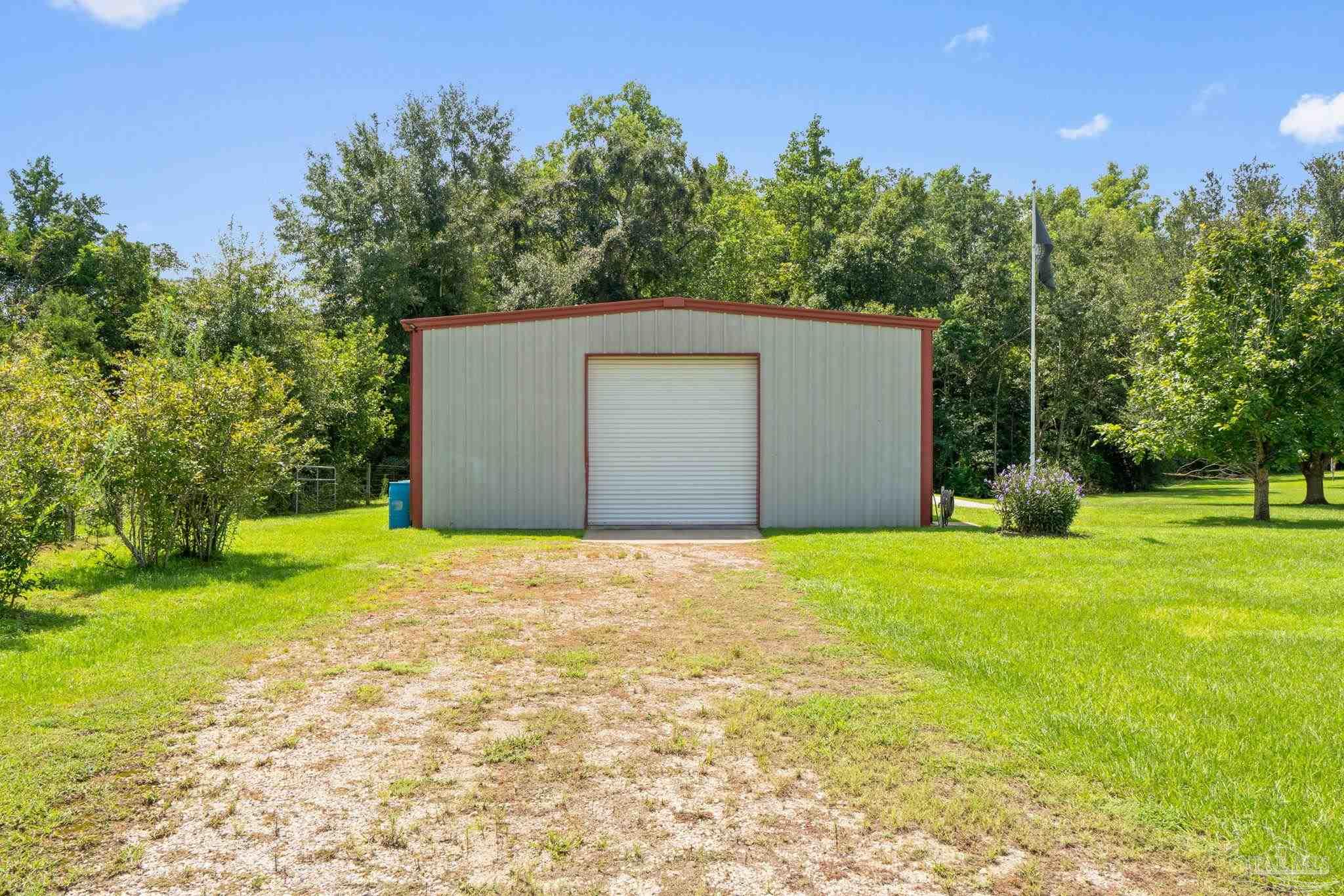 4381 Molino Road Molino, FL 32577 - Photo 59 of 72 a backyard of a house with plants and large trees