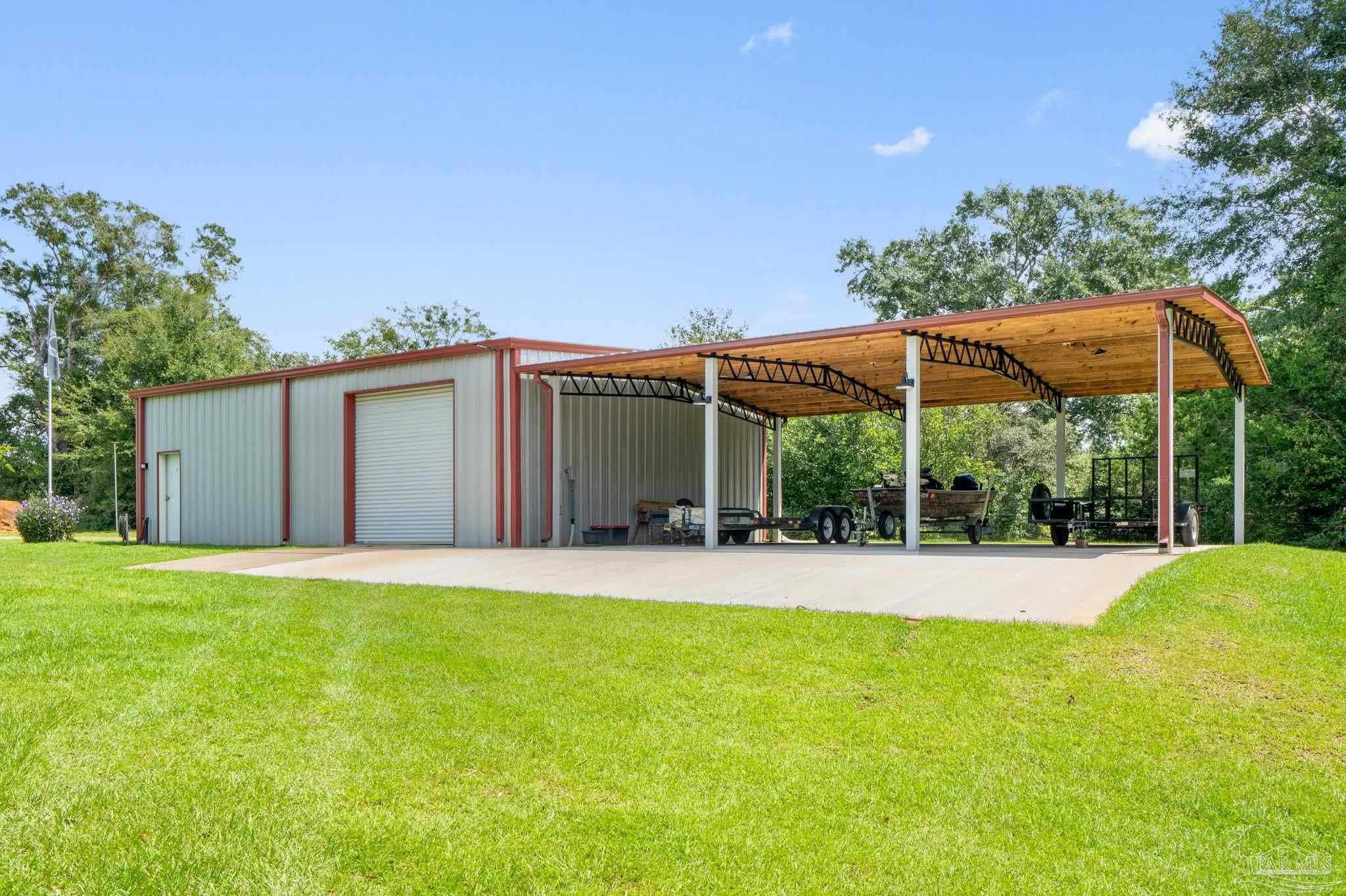 4381 Molino Road Molino, FL 32577 - Photo 62 of 72 a view of a house with a yard and potted plants