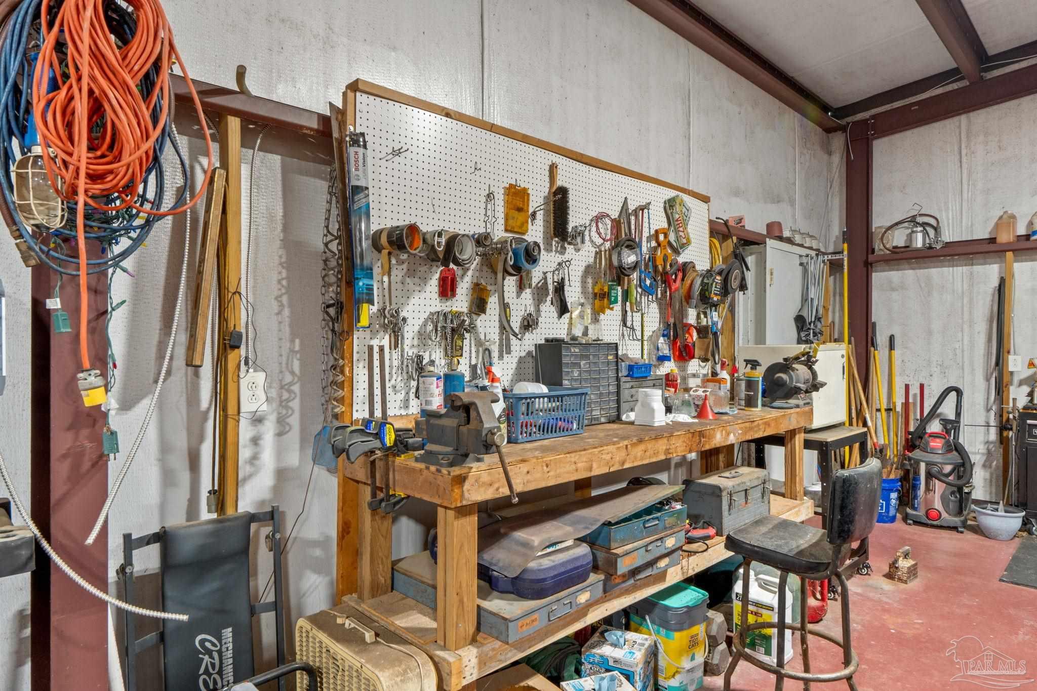 4381 Molino Road Molino, FL 32577 - Photo 67 of 72 a view of walk in closet with clothes and shoes