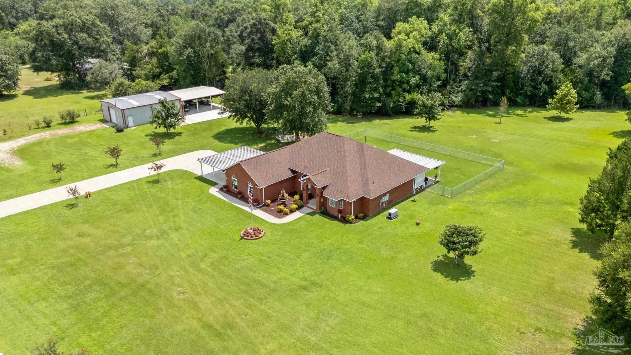 4381 Molino Road Molino, FL 32577 - Photo 68 of 72 an aerial view of a house with swimming pool and yard