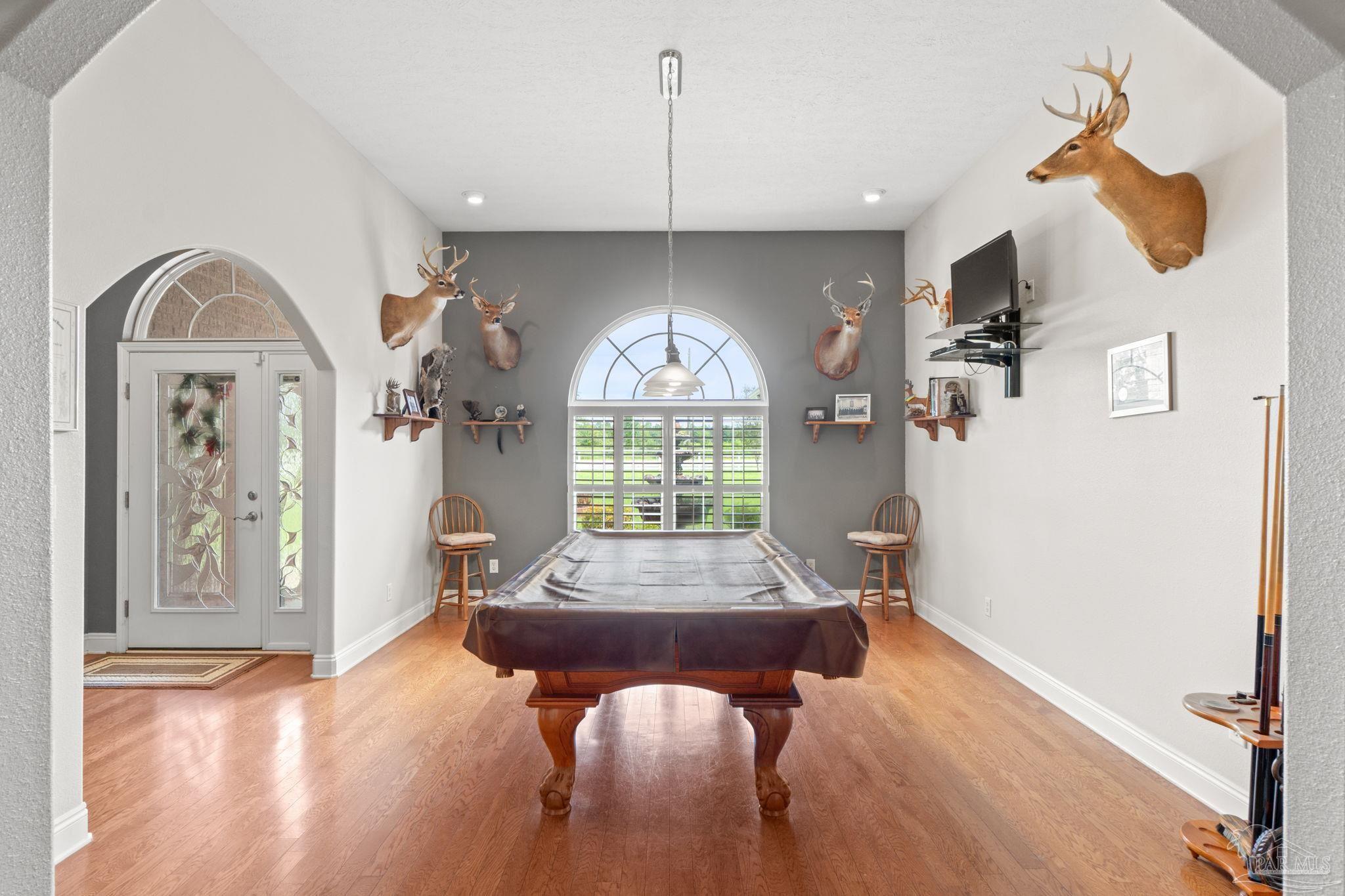 4381 Molino Road Molino, FL 32577 - Photo 10 of 72 a living room with furniture and a chandelier