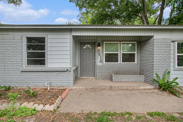 a view of a house and a yard and trees