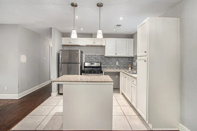 a kitchen with a stove a sink and a refrigerator