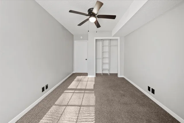 a view of empty room with ceiling fan