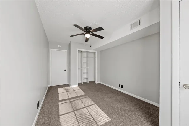 a view of a livingroom with a ceiling fan and window